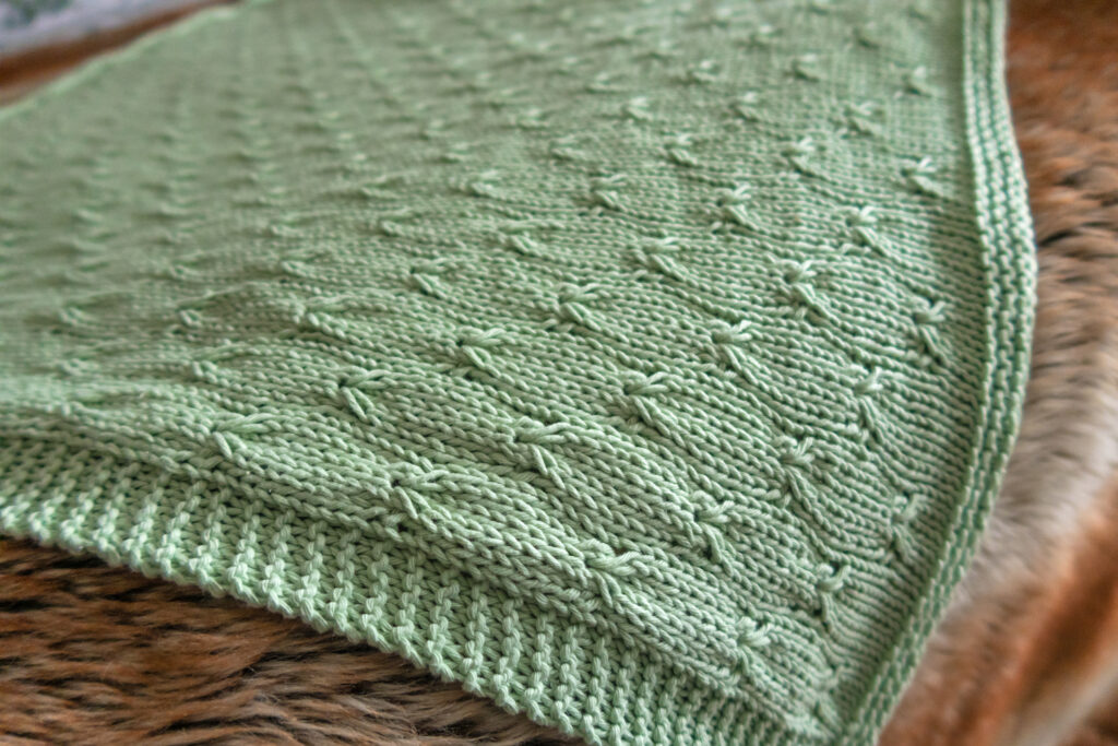green knitted baby blanket