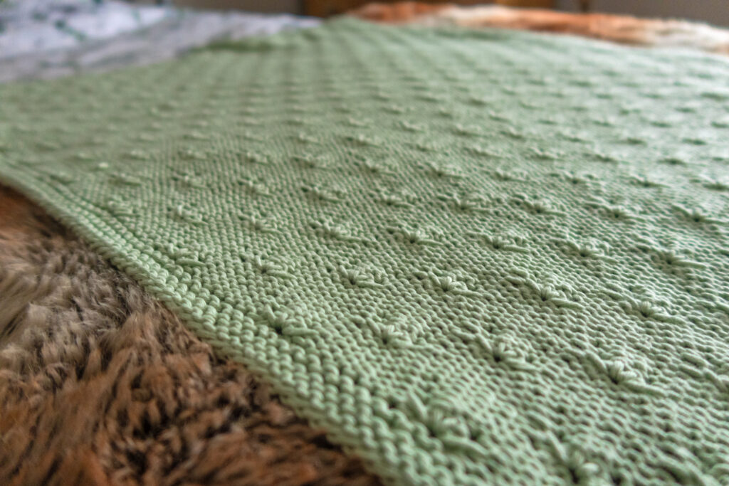 Green knitted baby blanket